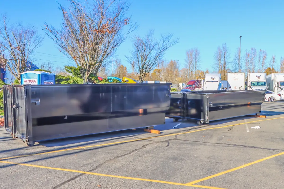 Professional dumpster rental service with roll-off container on residential driveway in Wimauma